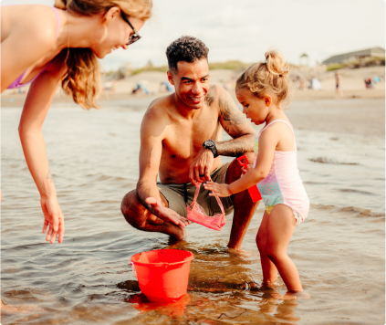 Family of three playing on a beach